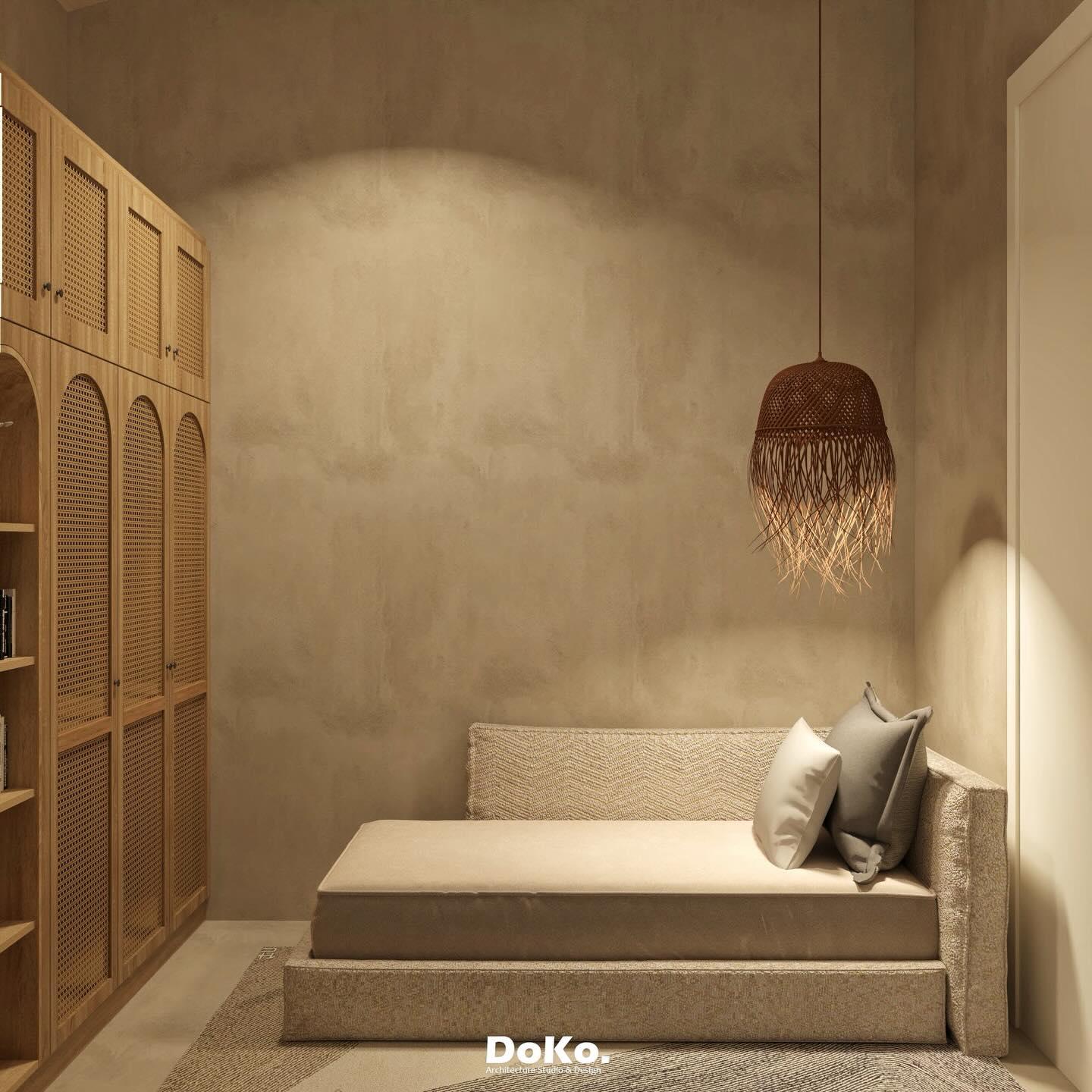 Minimal bedroom with limewash walls, arched timber wardrobe doors, a woven pendant lamp and a built-in upholstered bed.