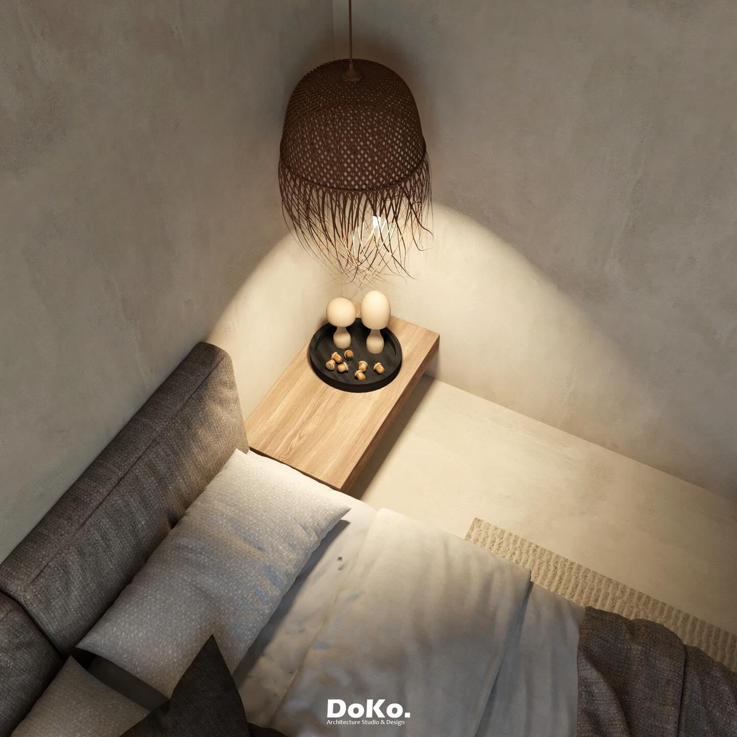 Top-down view of the bedside niche: a timber shelf with candles beneath the woven pendant.