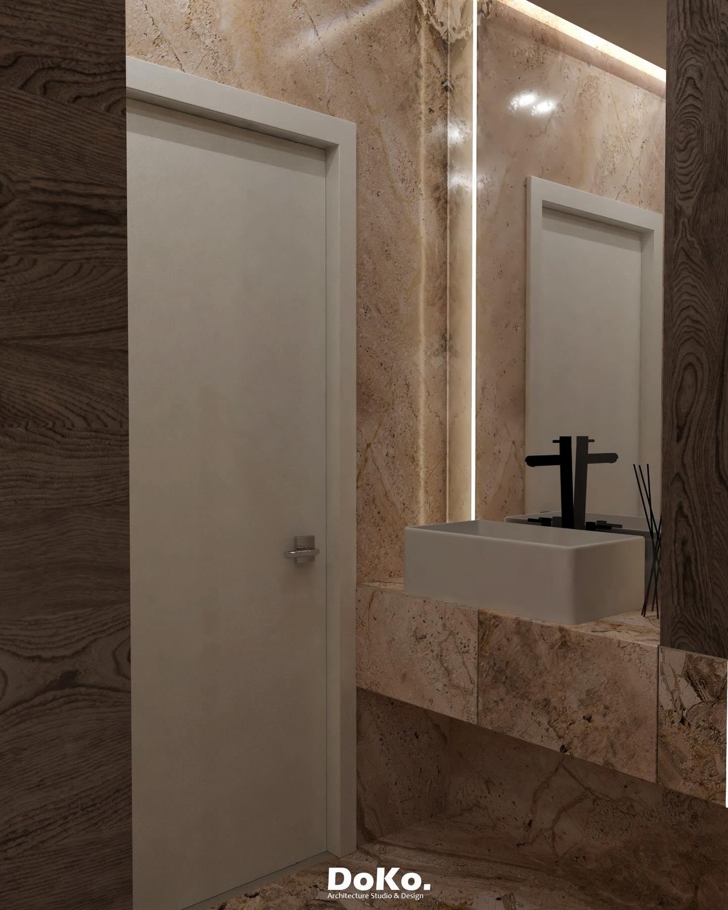 Vanity wall: floating marble washbasin with a black tap, a backlit mirror and a flush door.