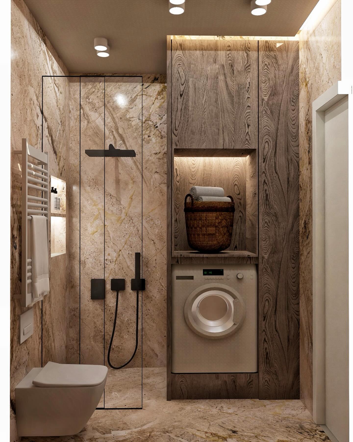 Full view of the marble bathroom: glass shower, black shower set, built-in washing machine and wall-hung WC.