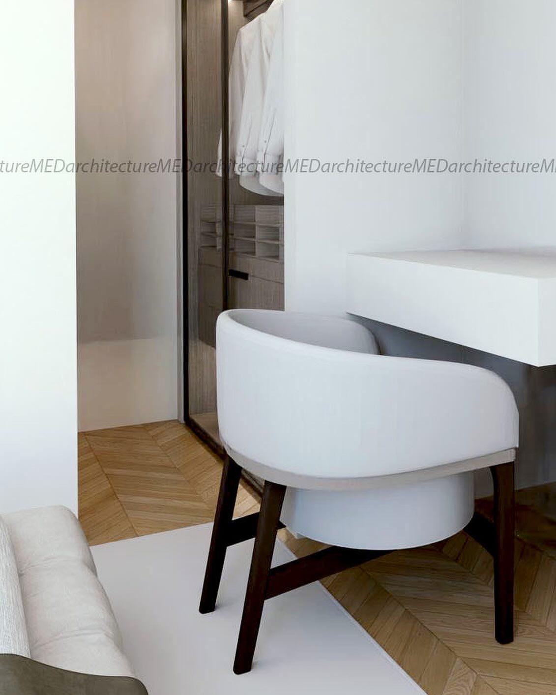 Close-up of the vanity chair and dressing table on a herringbone oak floor.