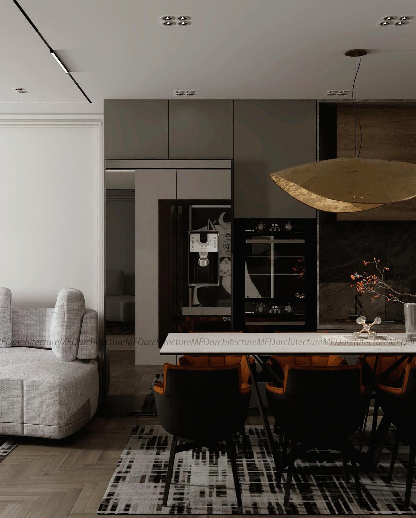 Open living and kitchen space: a grey sofa, a dark kitchen with integrated appliances and a pendant over the dining table.