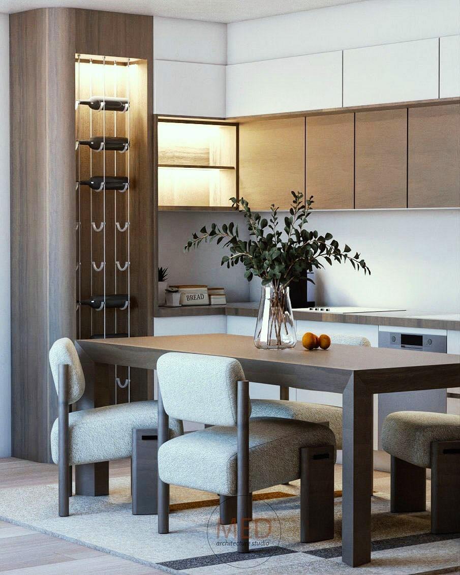 Kitchen and dining area: a timber table with pale chairs, a lit wine display and timber wall cabinets.