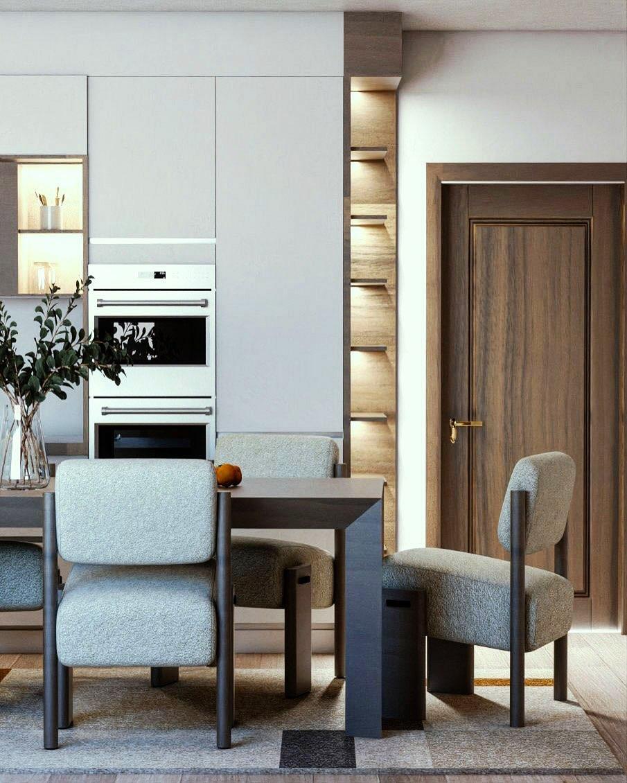 Dining area with a built-in oven column, lit timber shelving and a walnut door.