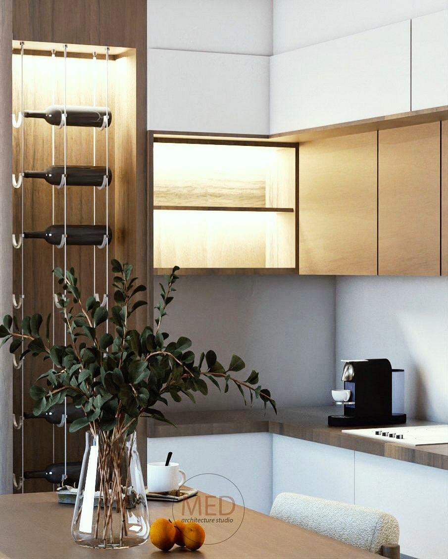 Kitchen corner with lit shelving, wine storage and a coffee machine on the worktop.